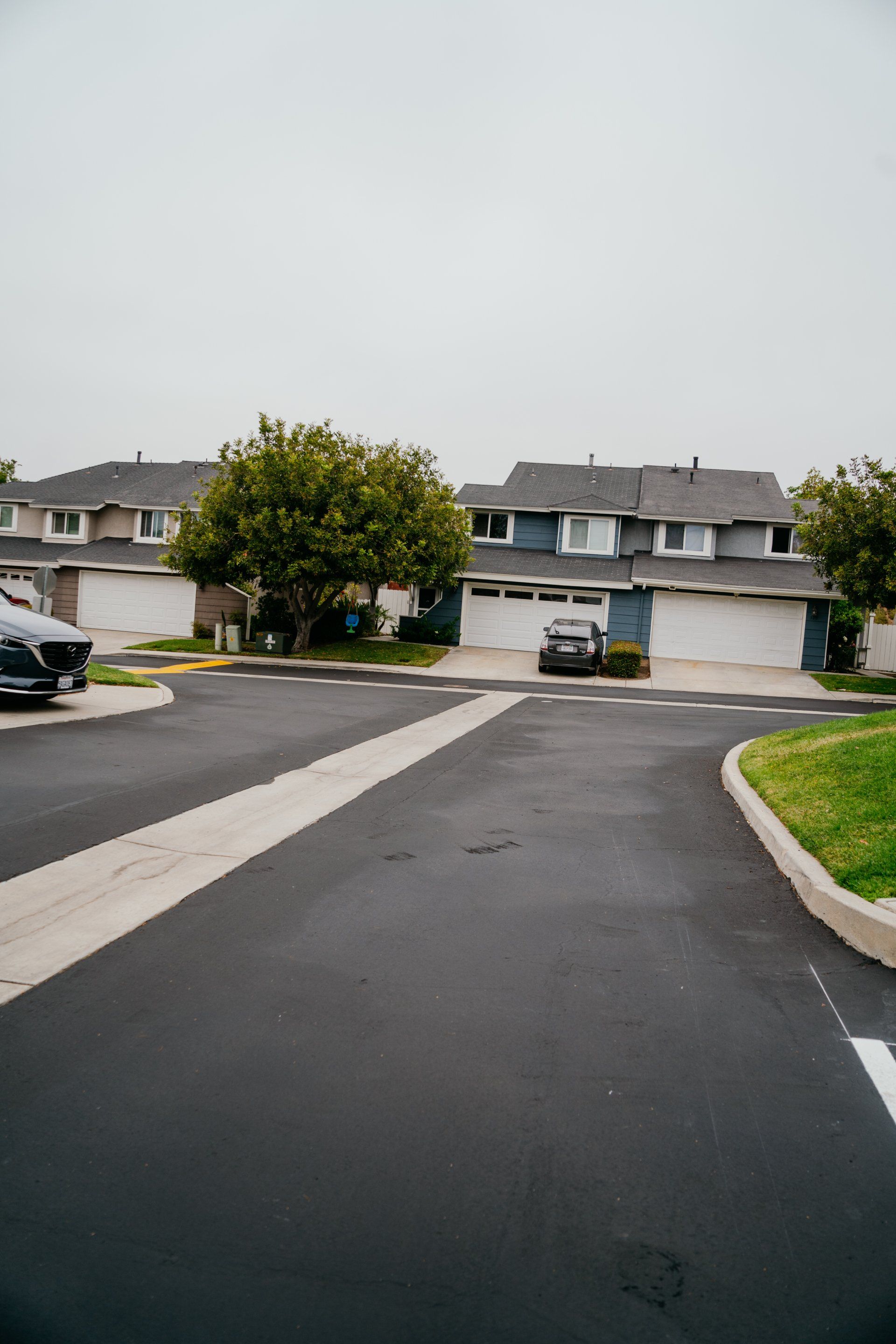 A row of houses are lined up on the side of a road