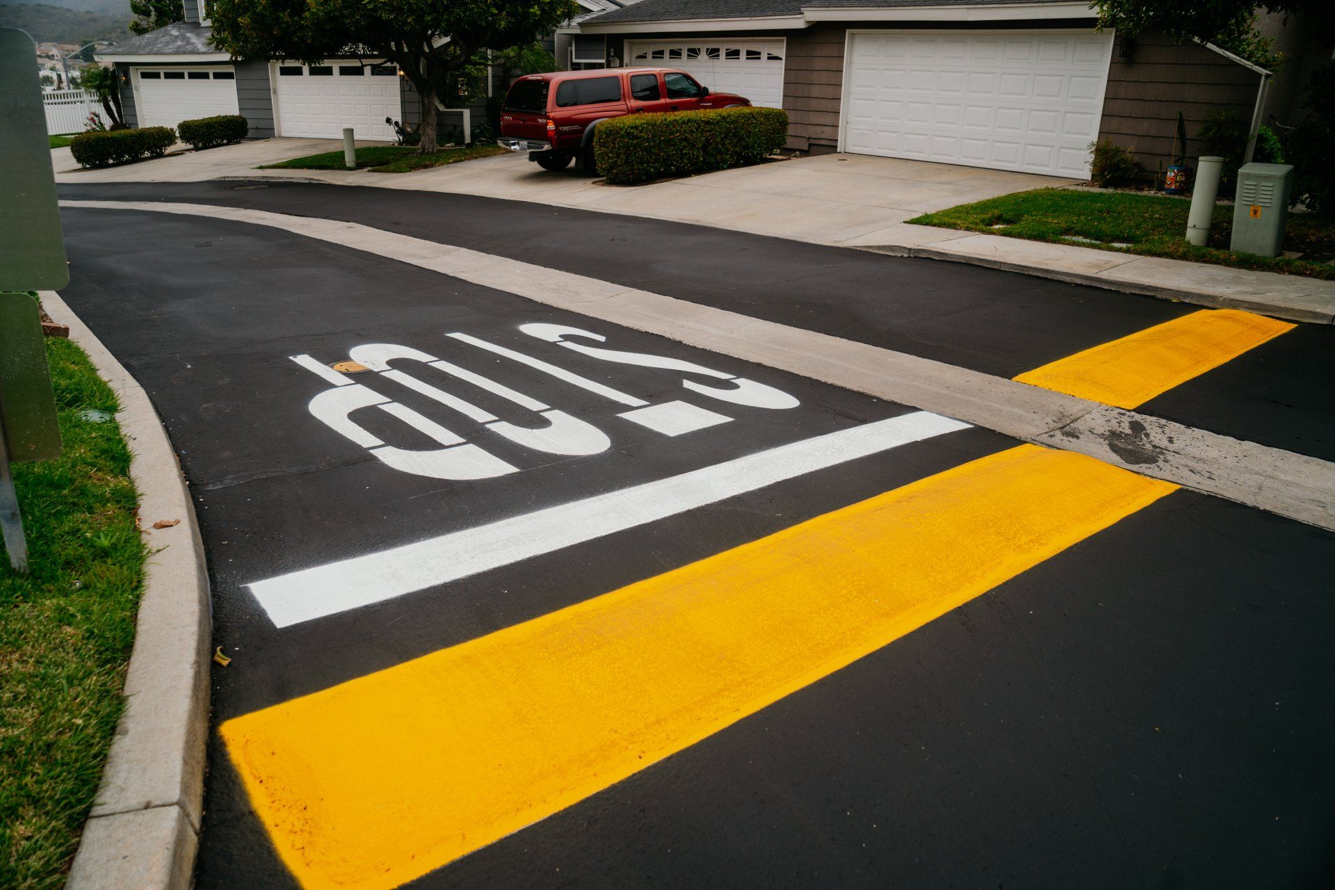 A stop sign is painted on the side of the road