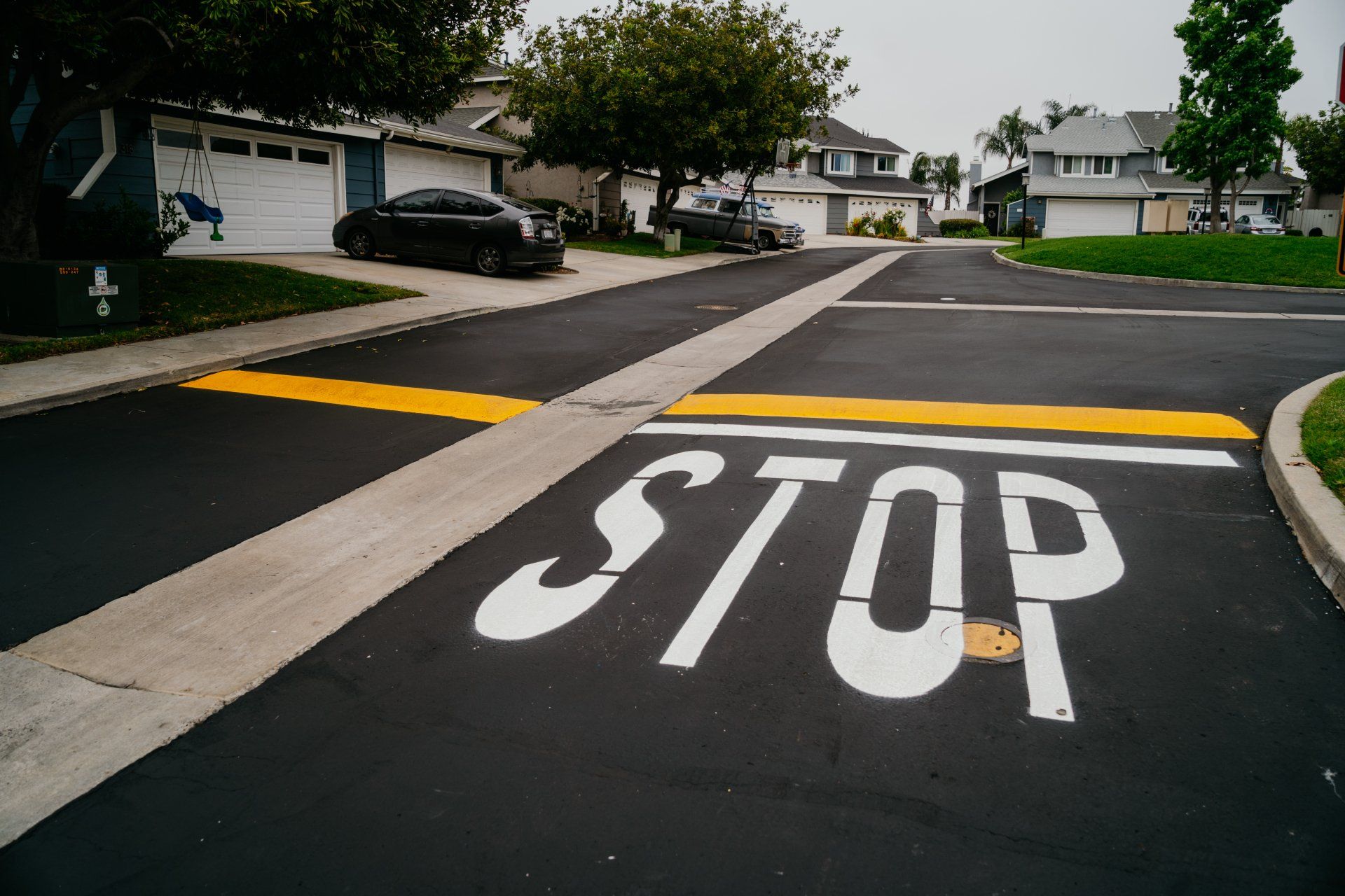A stop sign is painted on the side of the road