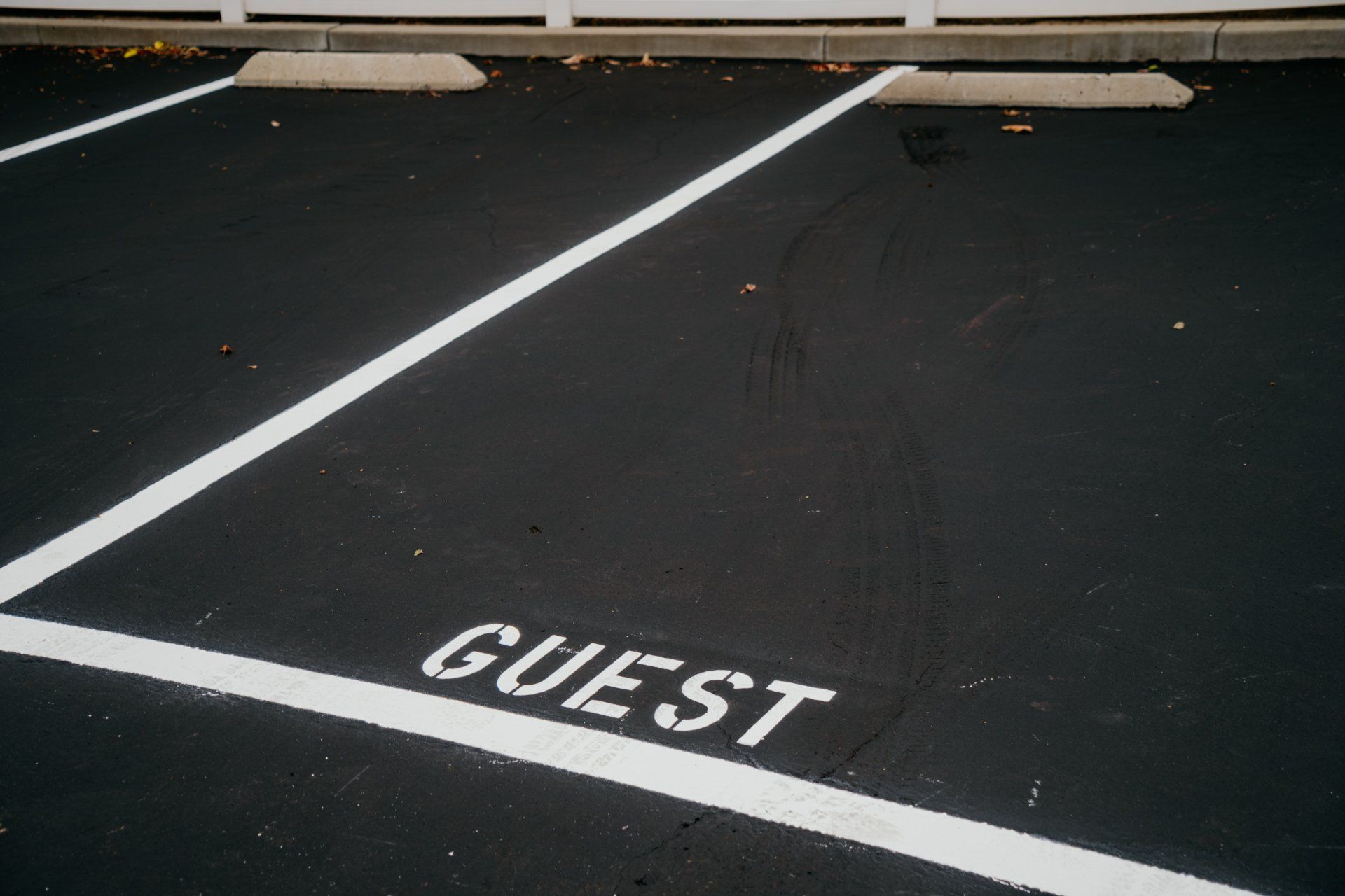 The word guest is painted on the side of a parking lot