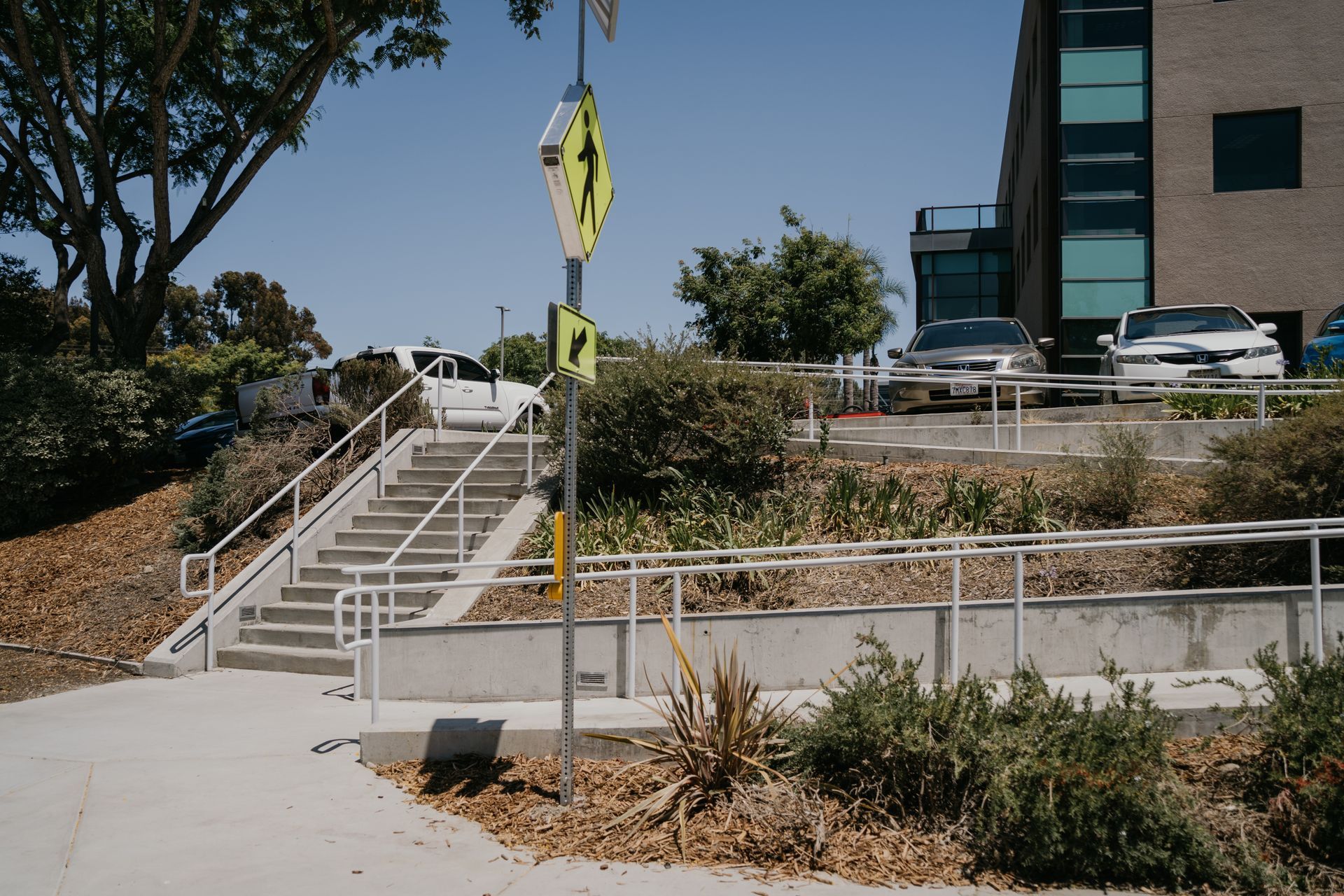 A staircase with a yellow sign on the side of it