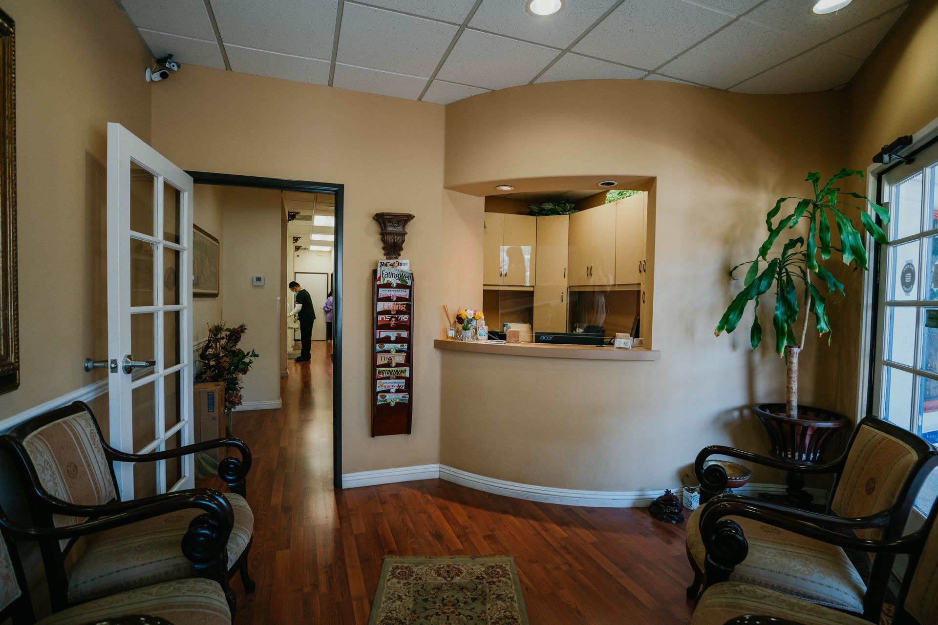 A waiting room with chairs and a counter in a dental office.
