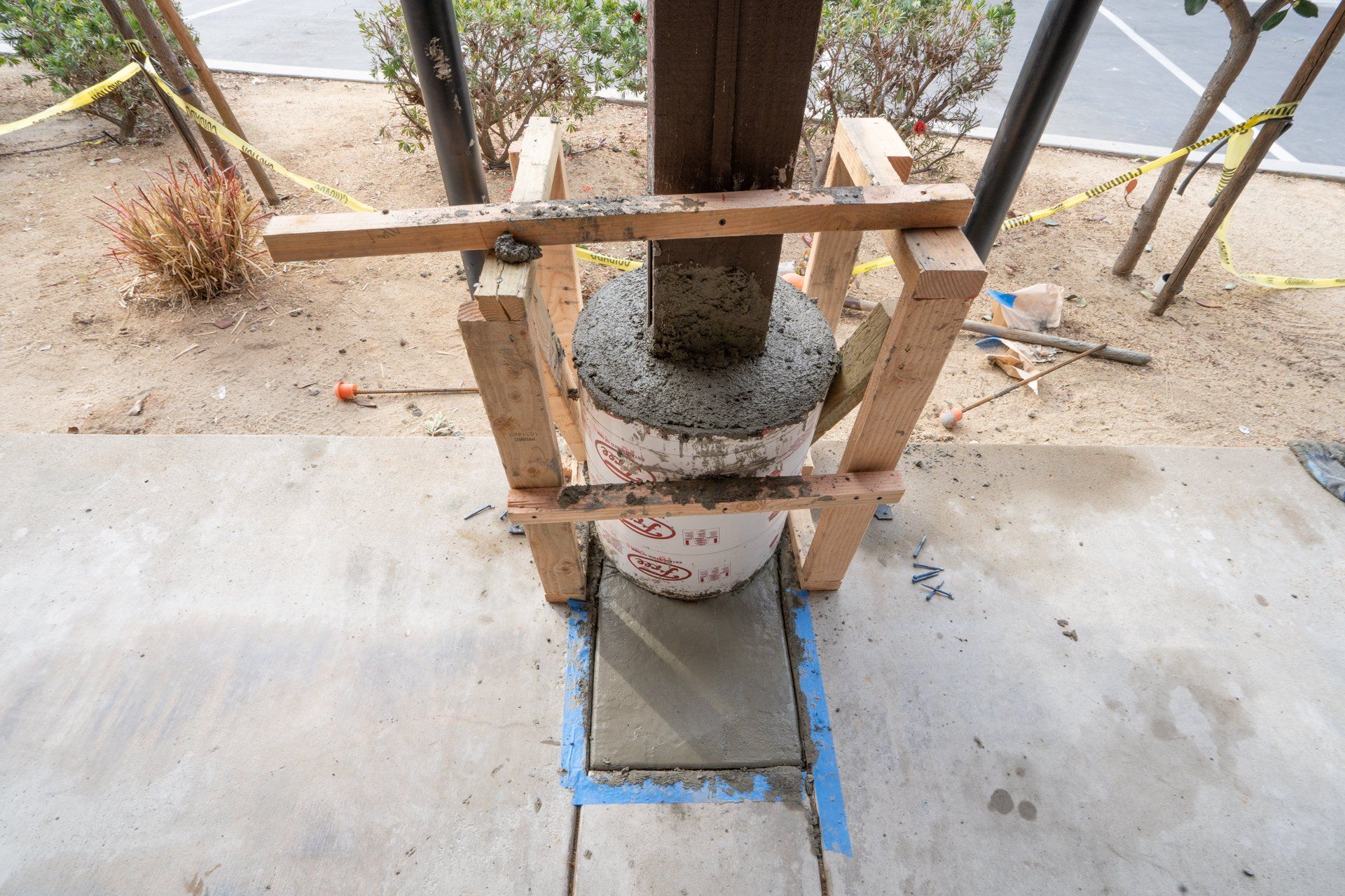 A concrete block is sitting on top of a wooden frame on a sidewalk.