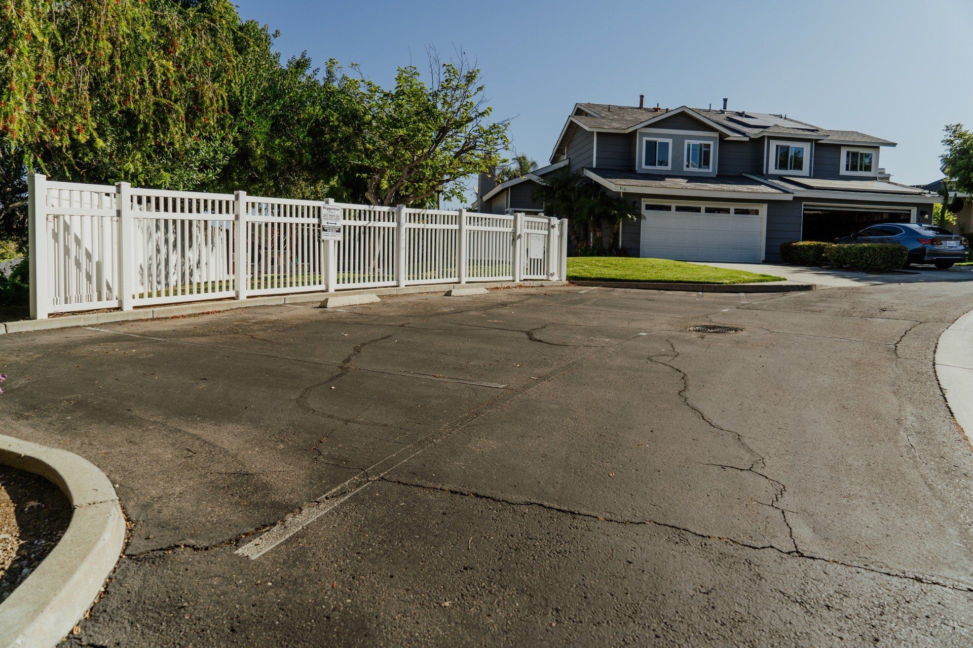 A house with a white fence in front of it