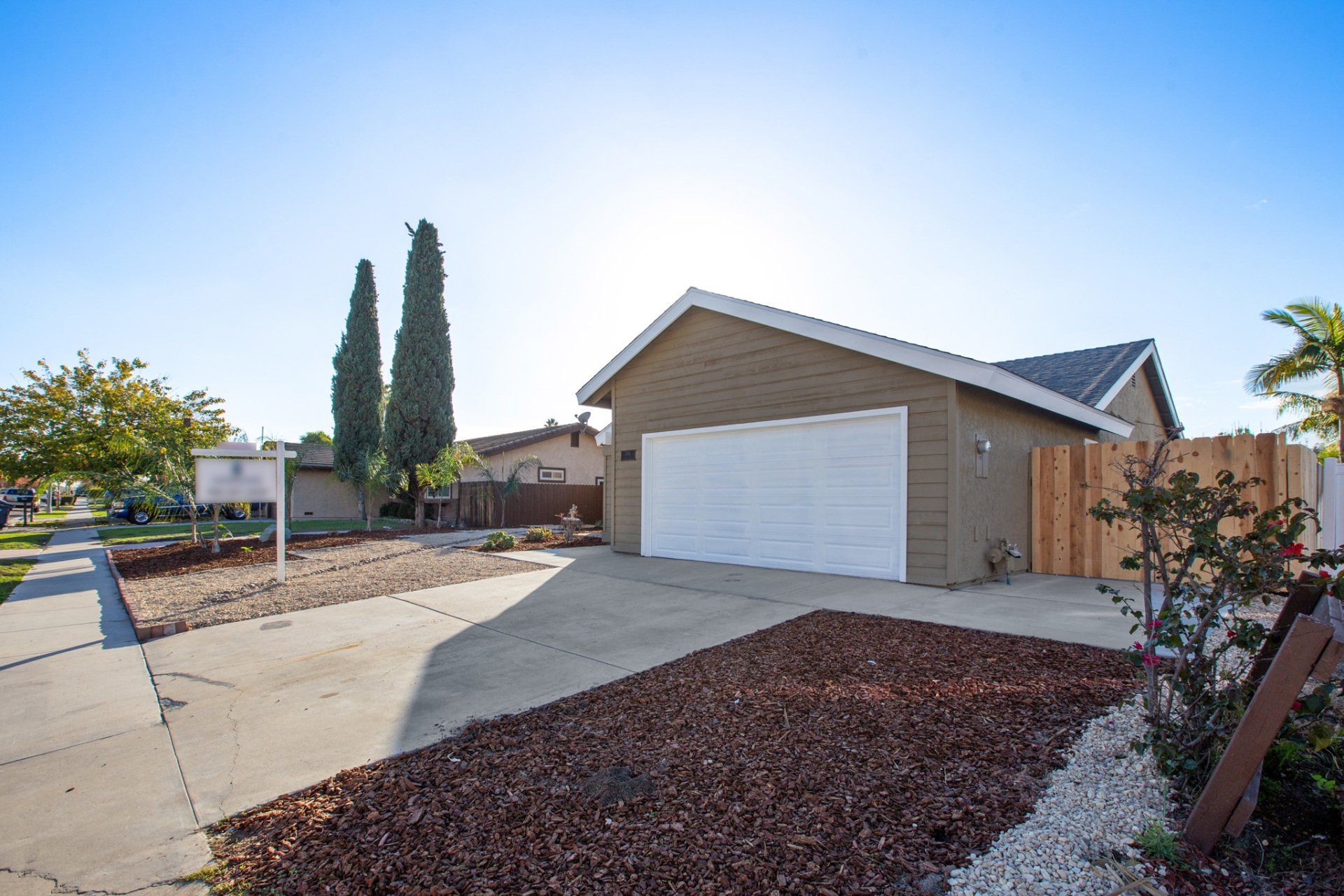 A house with a white garage door is for sale