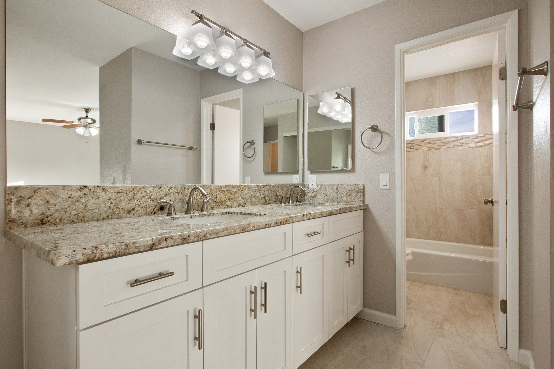 A bathroom with two sinks and a large mirror