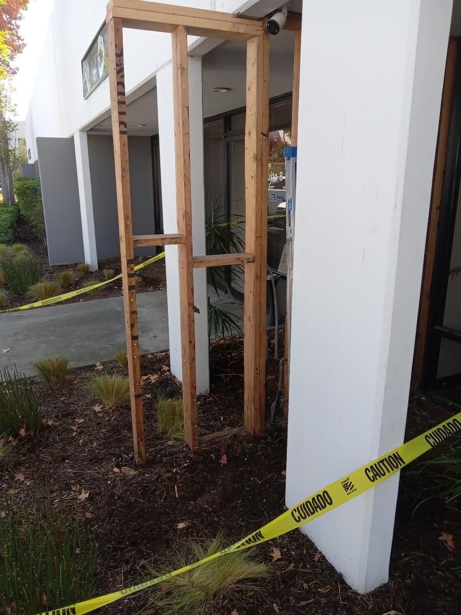 A wooden frame is being built on the side of a building