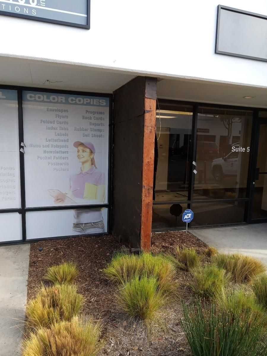 The front of a building with a sign on the window that says 