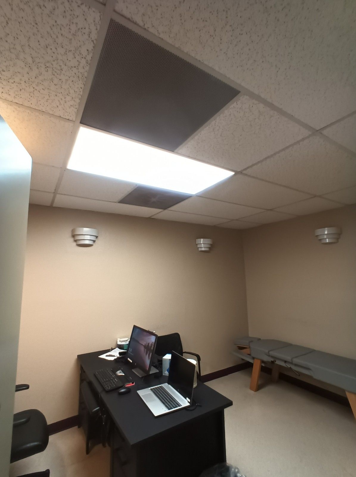 A room with a desk and a laptop on it