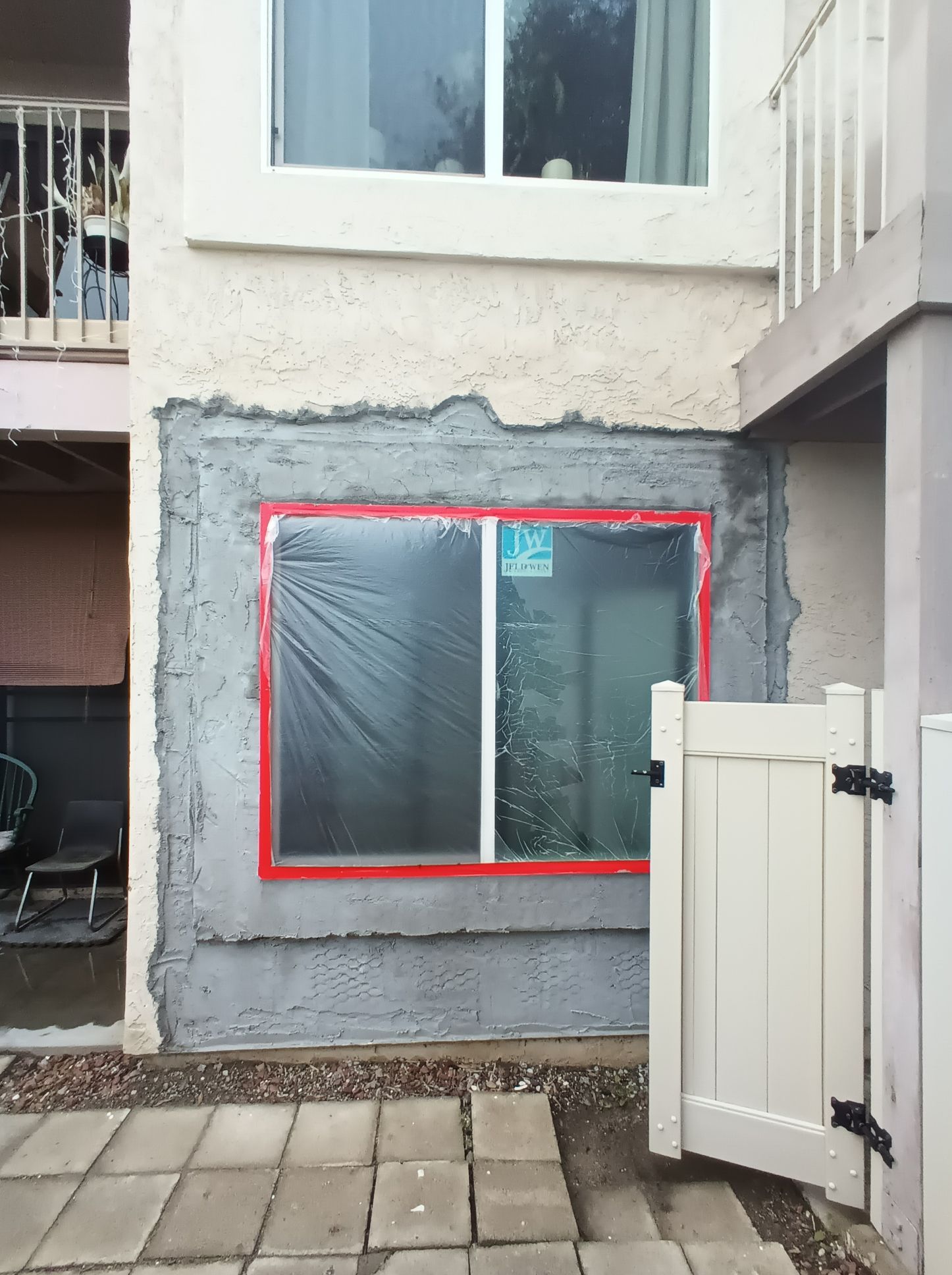 A building with a window that is covered in plastic