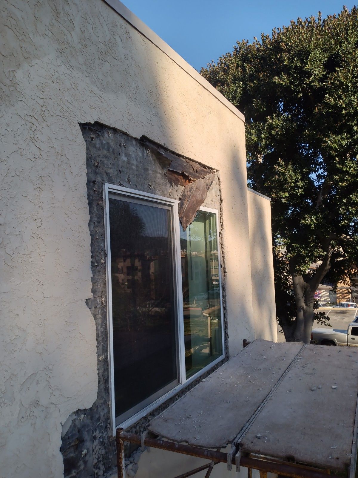 A window is being installed on the side of a building