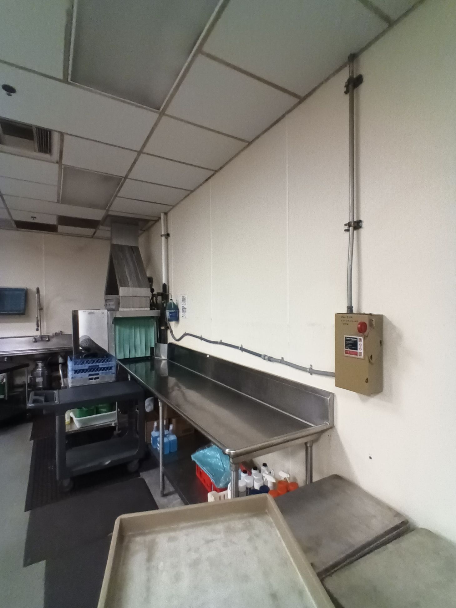 A kitchen with a stainless steel counter and a dishwasher