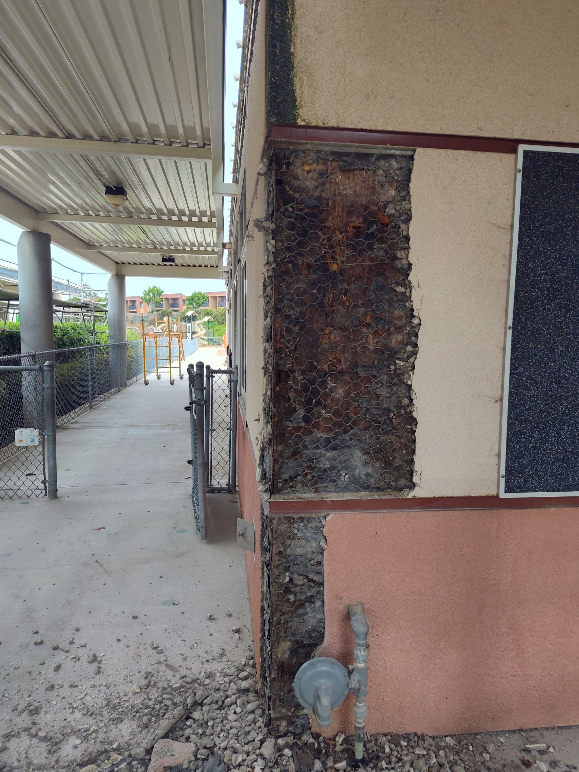 A corner of a building with a hole in it