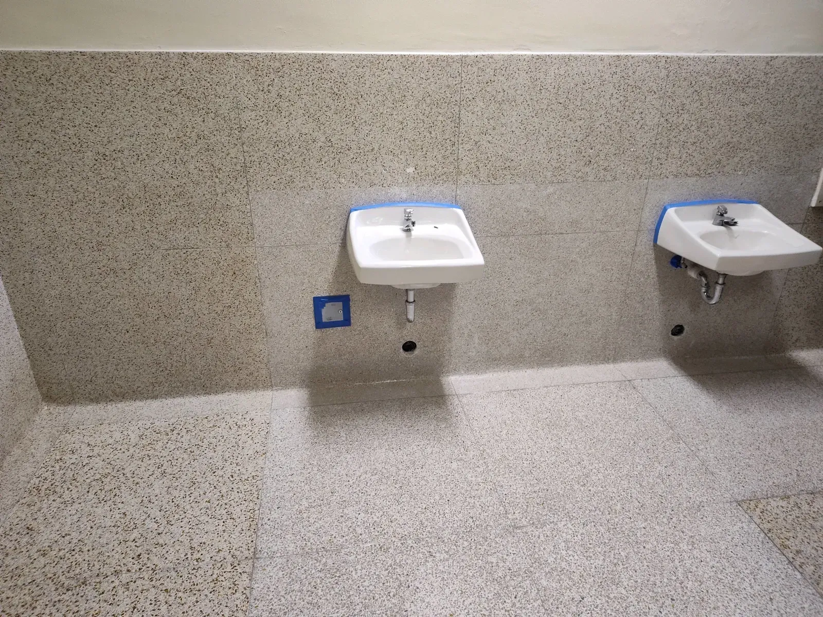 Two sinks are sitting next to each other in a bathroom.
