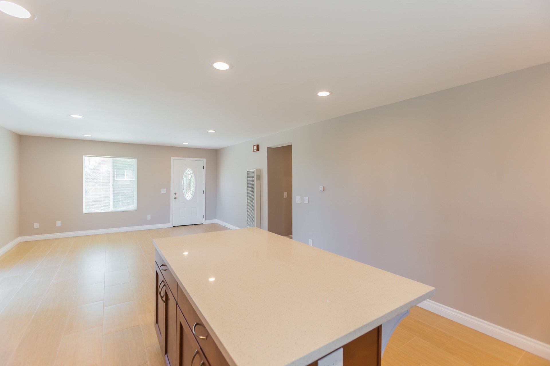 An empty kitchen with a large island in the middle