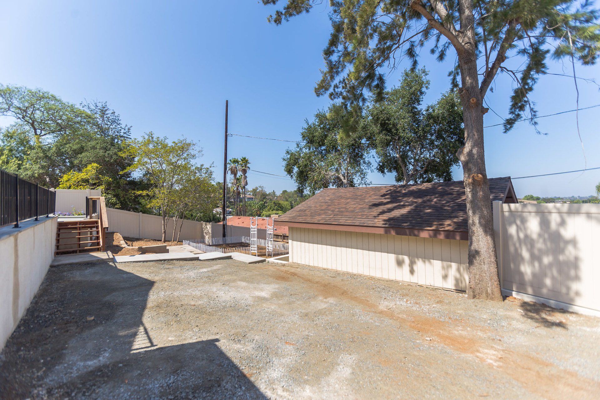 A fenced in area with a tree in the middle of it