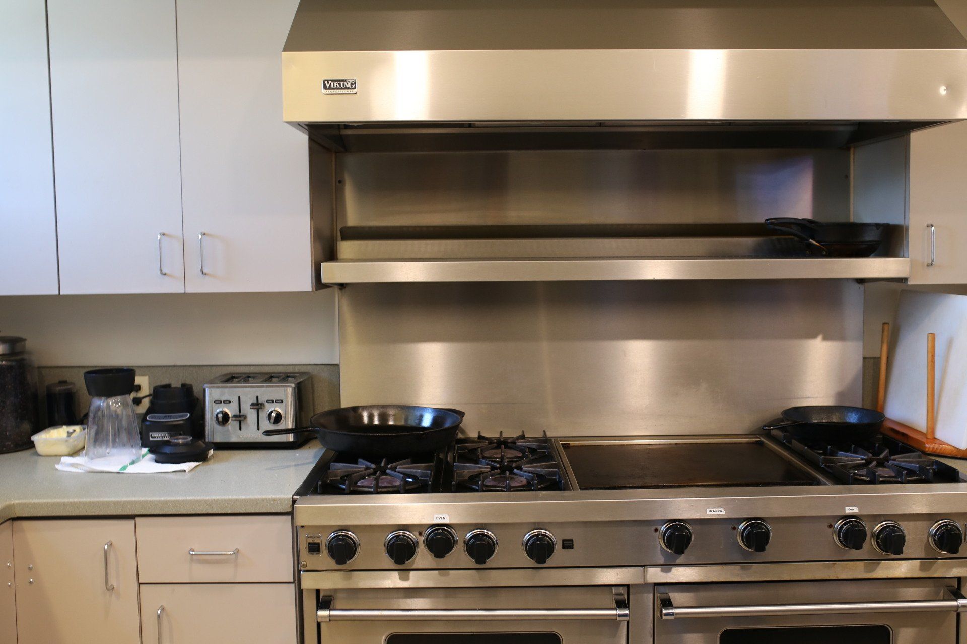 A kitchen with a stainless steel stove top oven