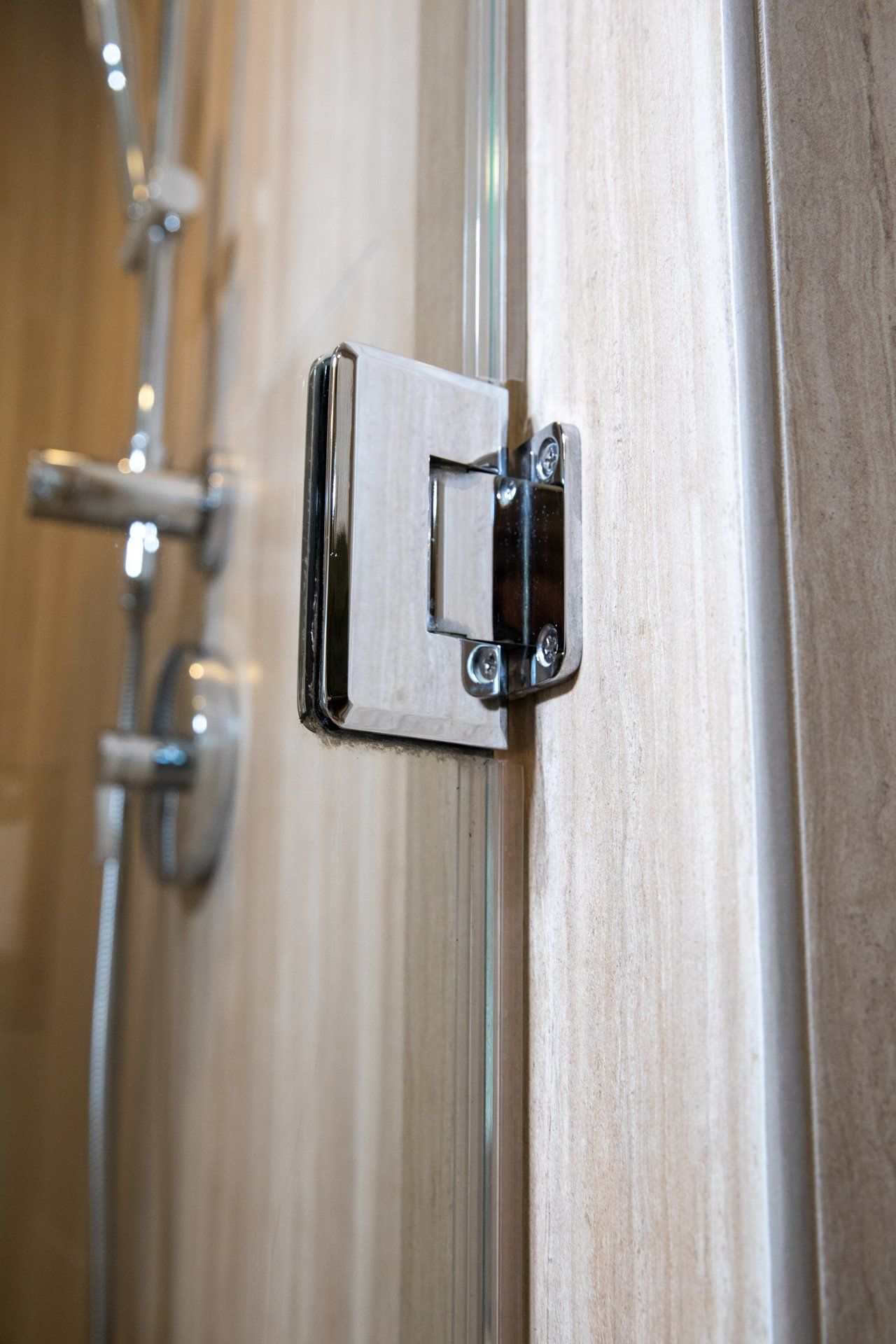 A close up of a door hinge in a bathroom