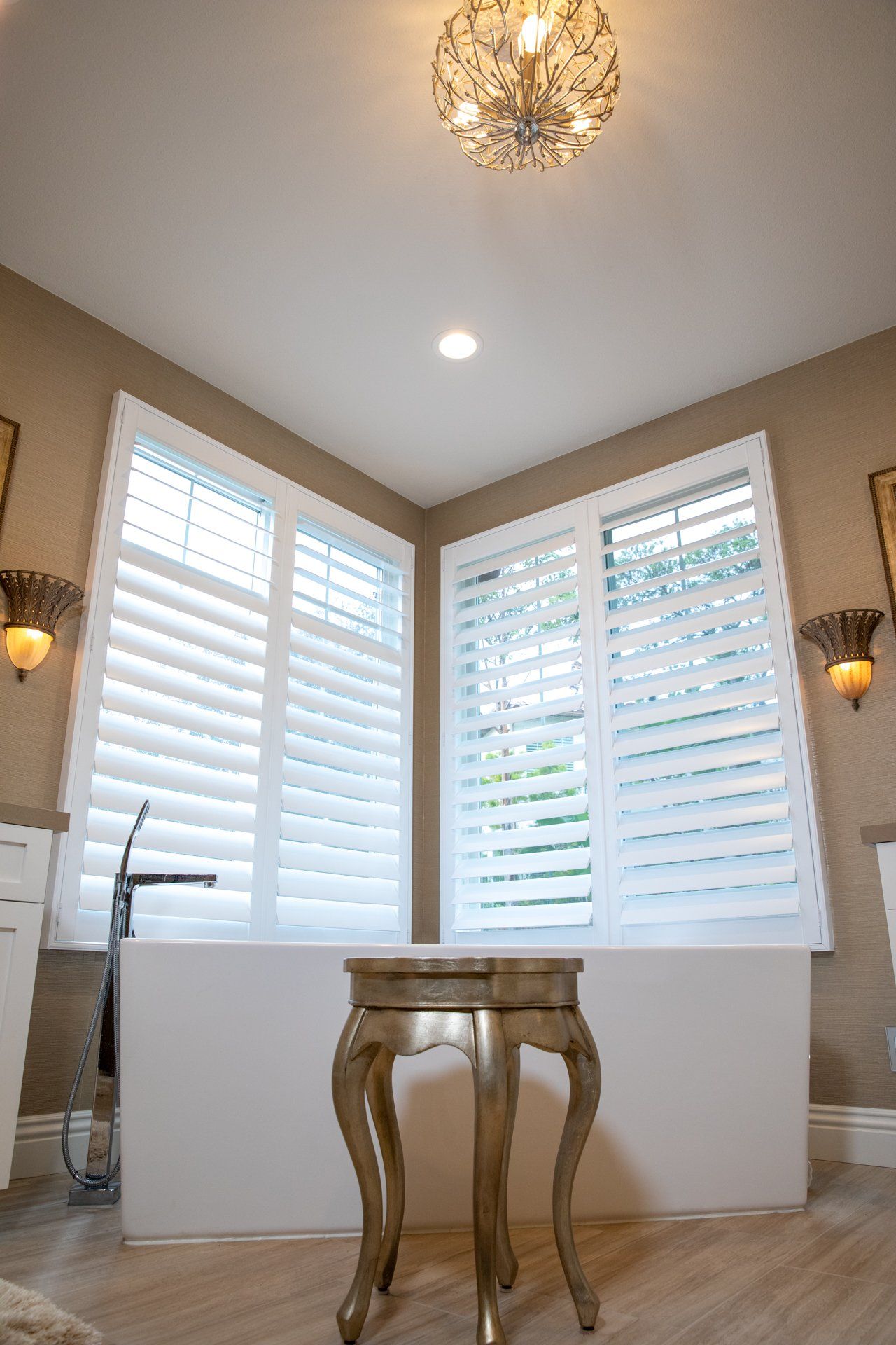 A bathroom with a bathtub and a table in front of it