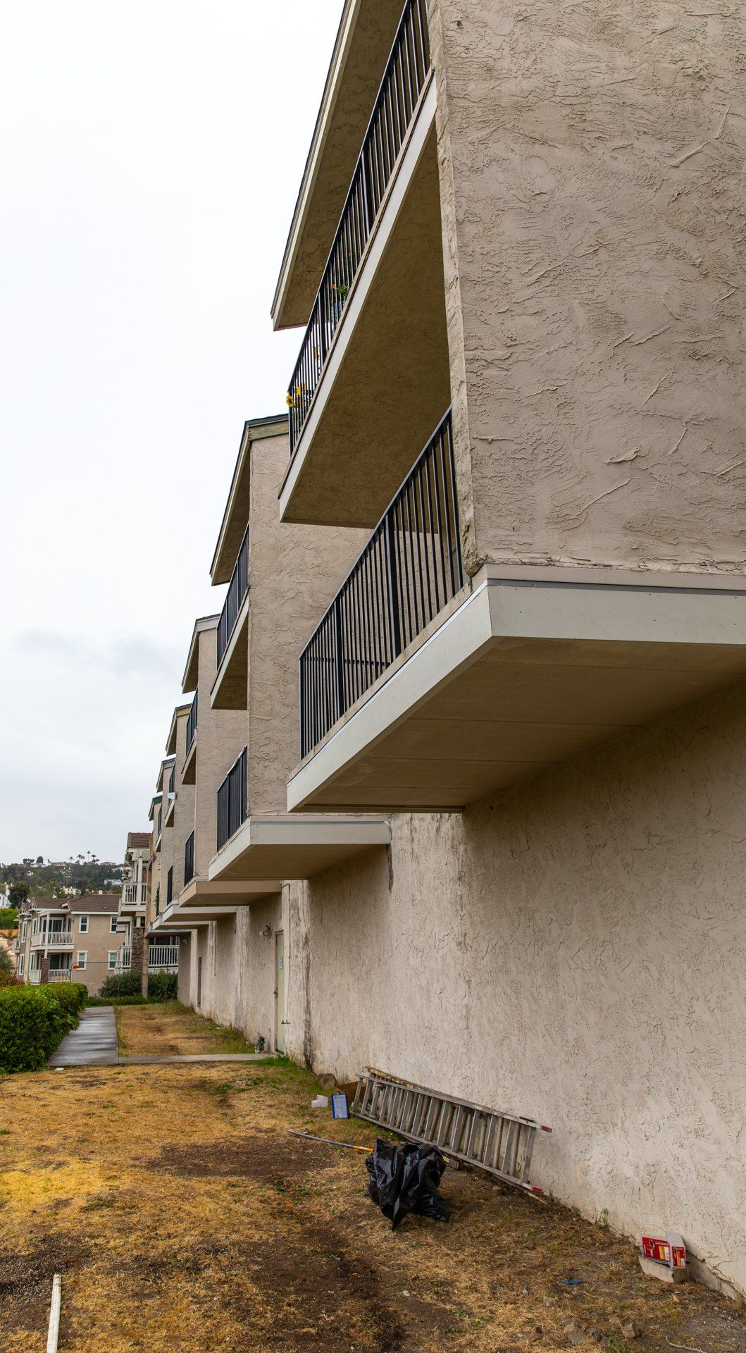 A row of apartment buildings with balconies on the side