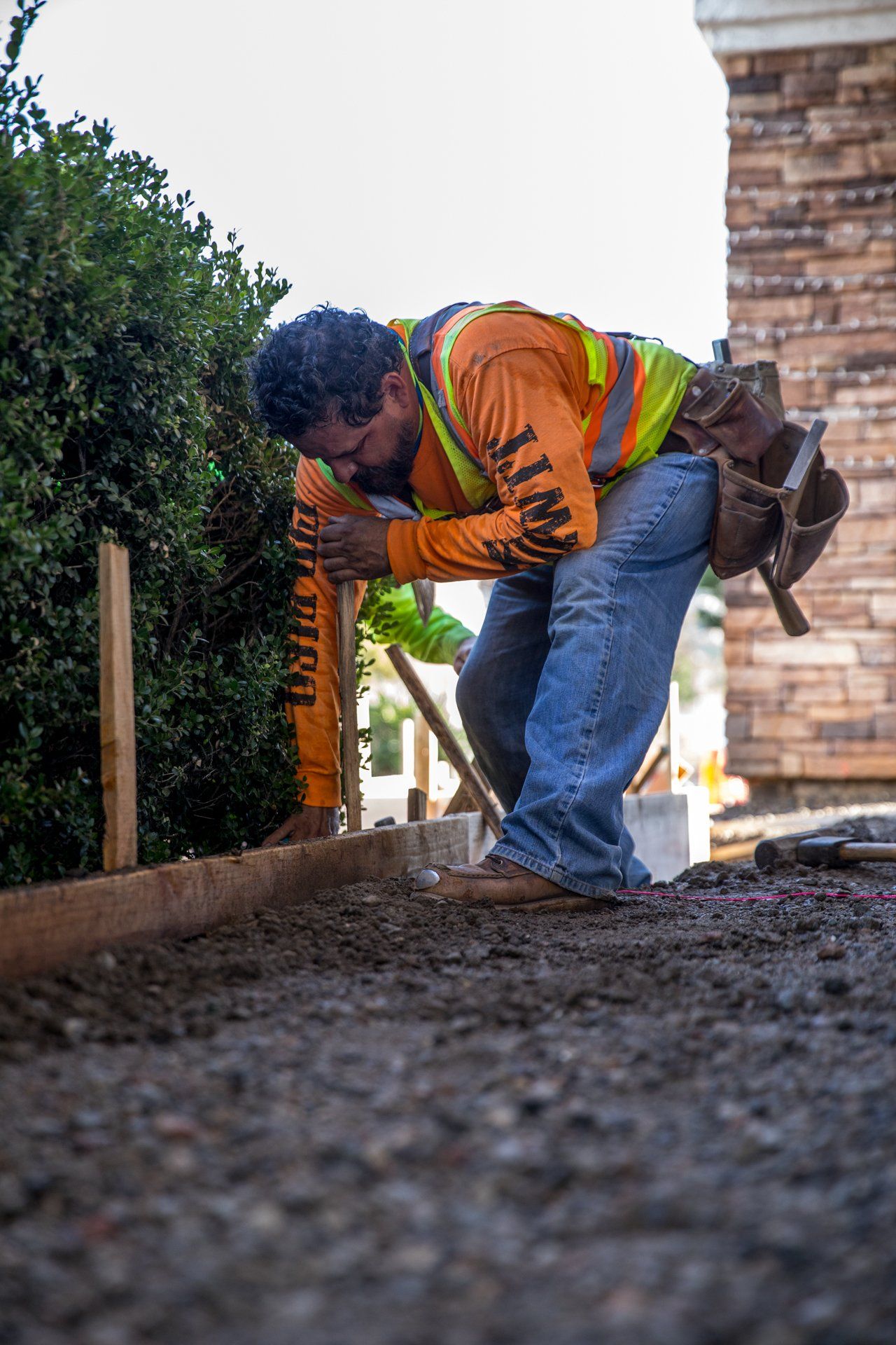 A construction worker wearing a safety vest with the word caution on it