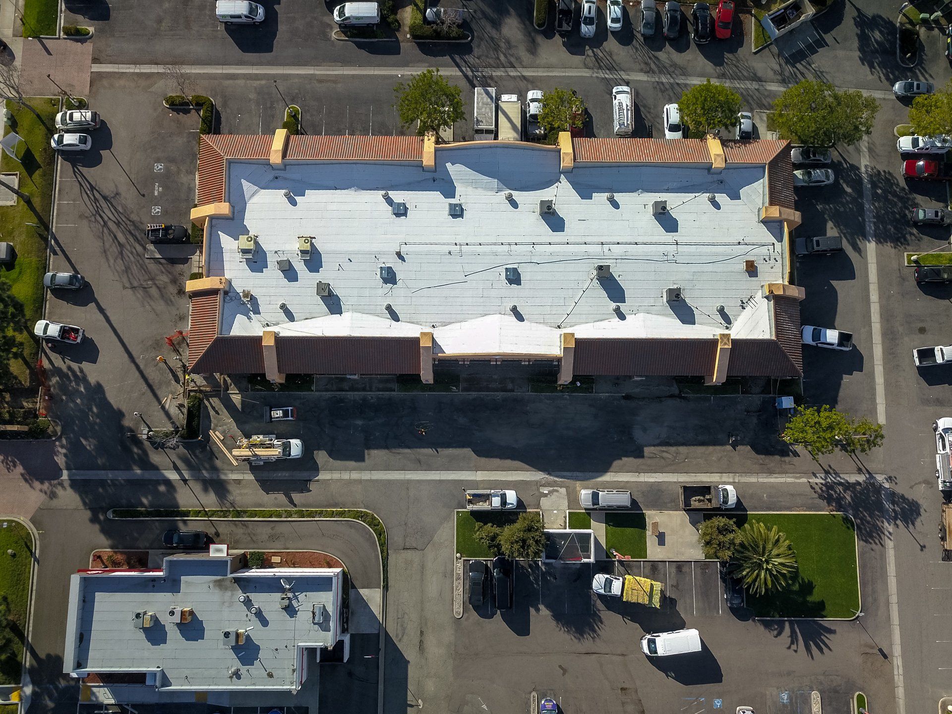 An aerial view of a building with a white roof