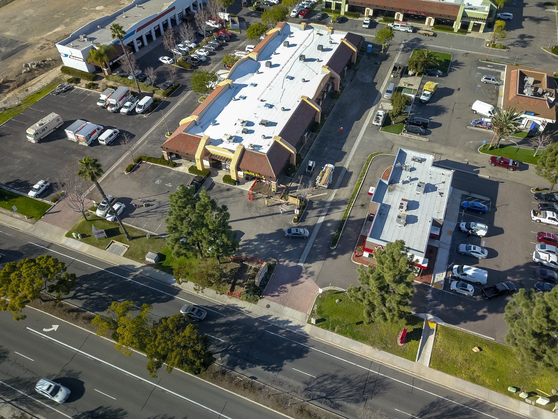 An aerial view of a parking lot and a restaurant