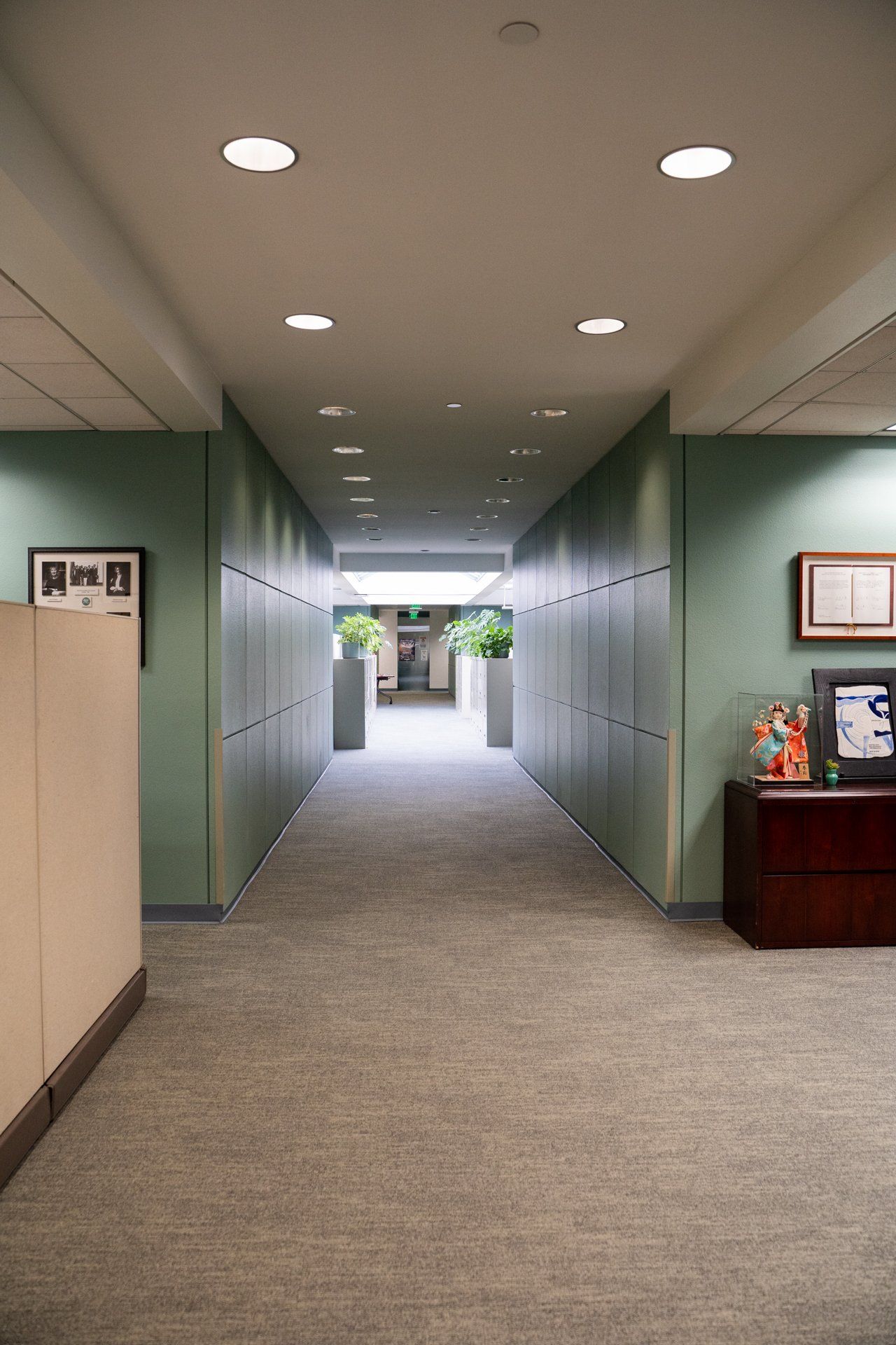 A long hallway between two cubicles in an office building.