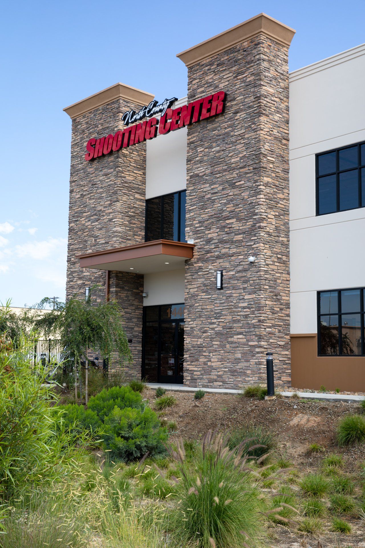 A large building with a stone facade and a sign that says survival center.