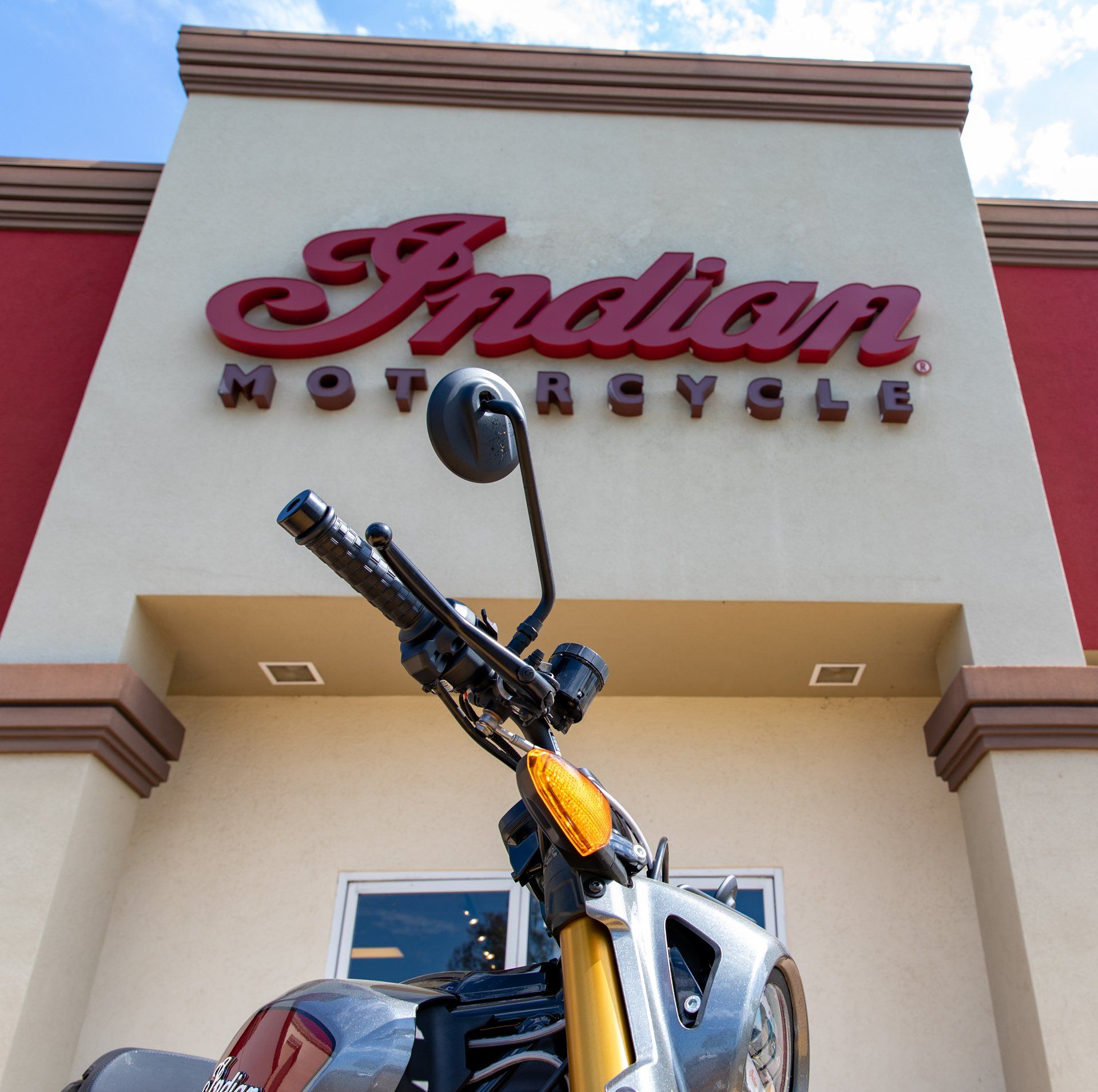 A motorcycle is parked in front of an indian motorcycle store