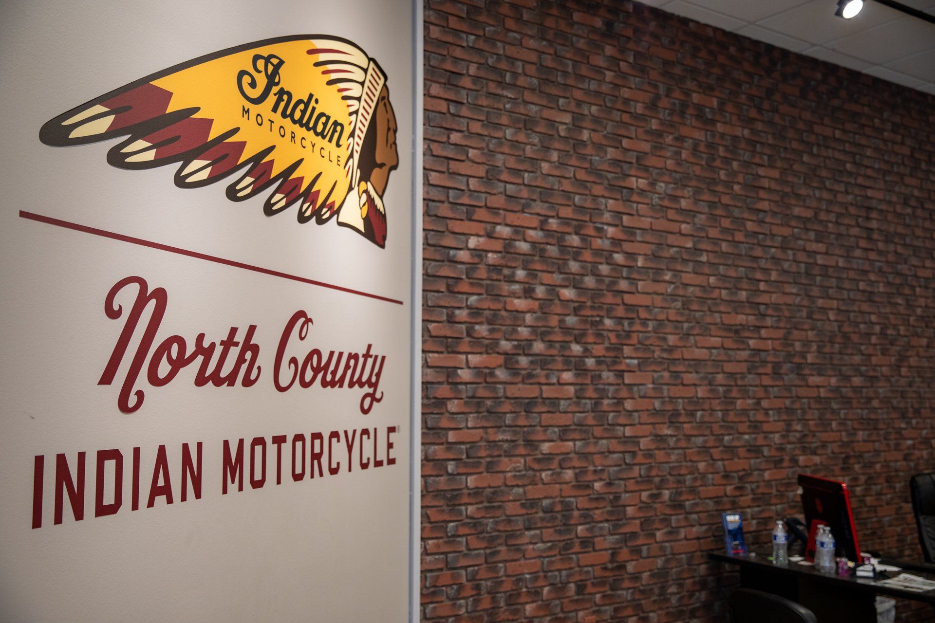 A sign on a wall that says north county indian motorcycle