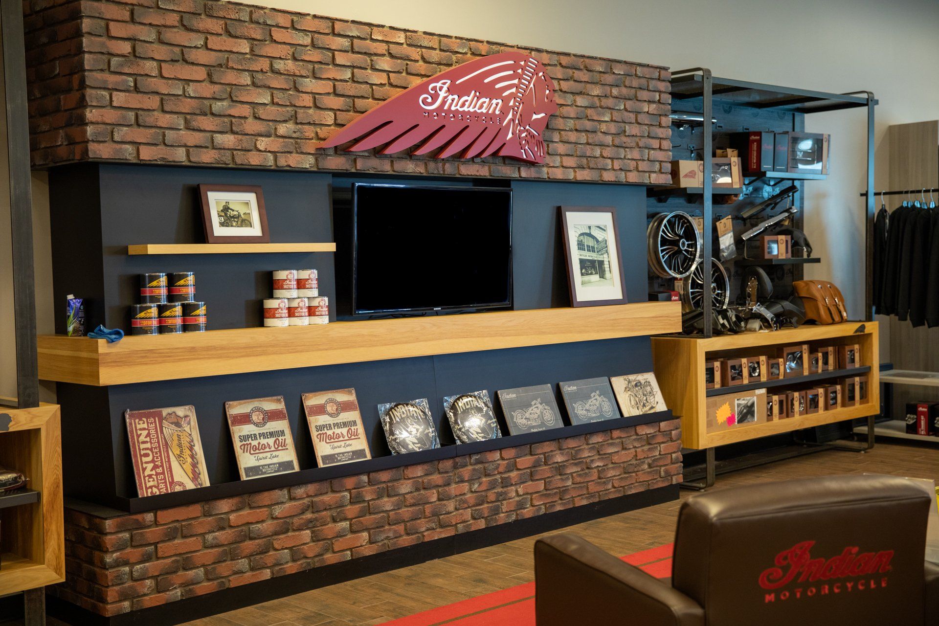 A living room with a brick wall and a television on the wall.