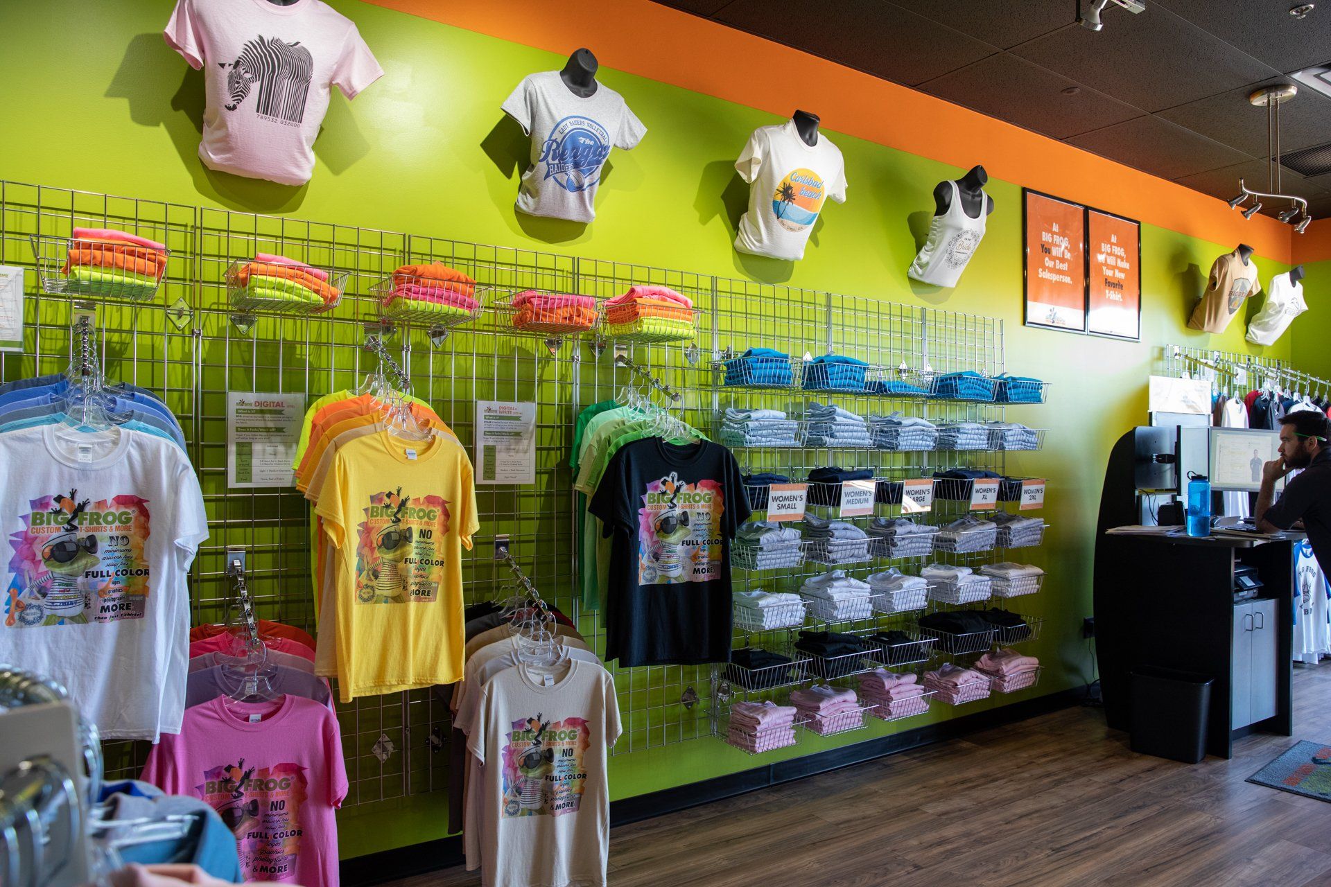 A store filled with lots of shirts hanging on the wall.