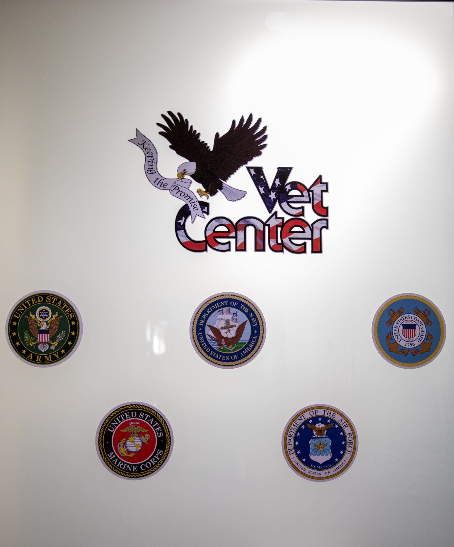 A vet center logo is on a white wall