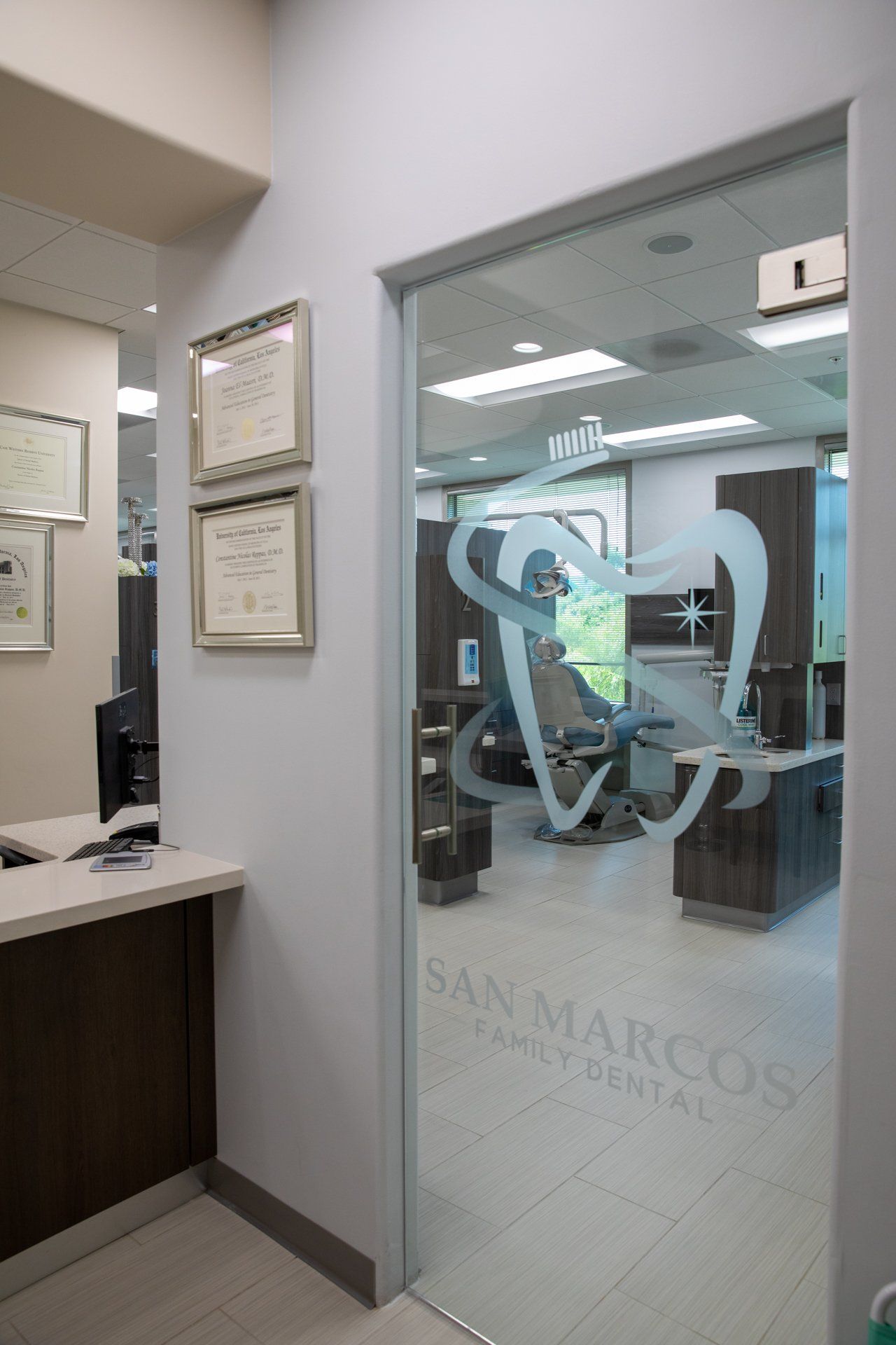 A dental office with a glass door and a tooth on the glass door.