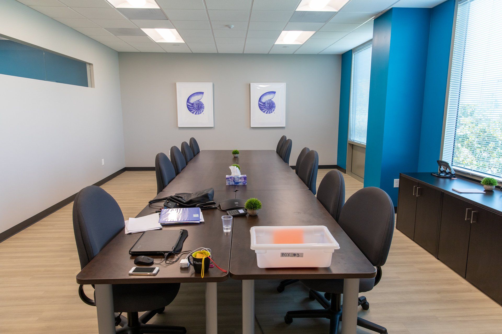 A conference room with a long table and chairs.