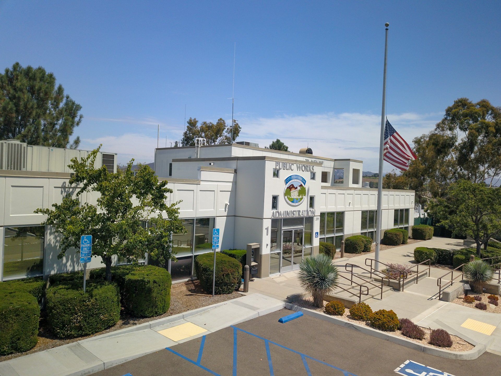 A large white building with a flag in front of it