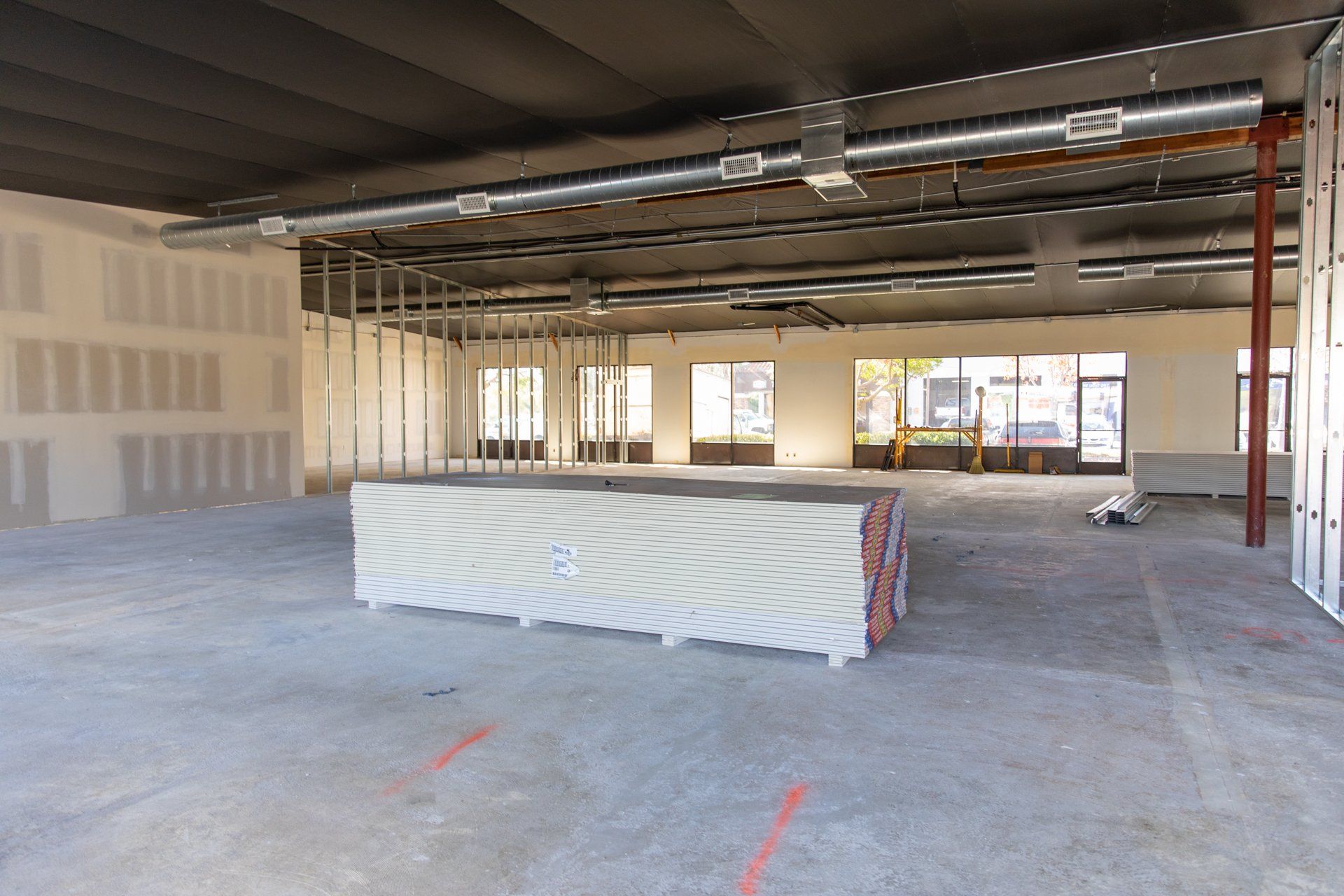 A large empty room with a concrete block in the middle