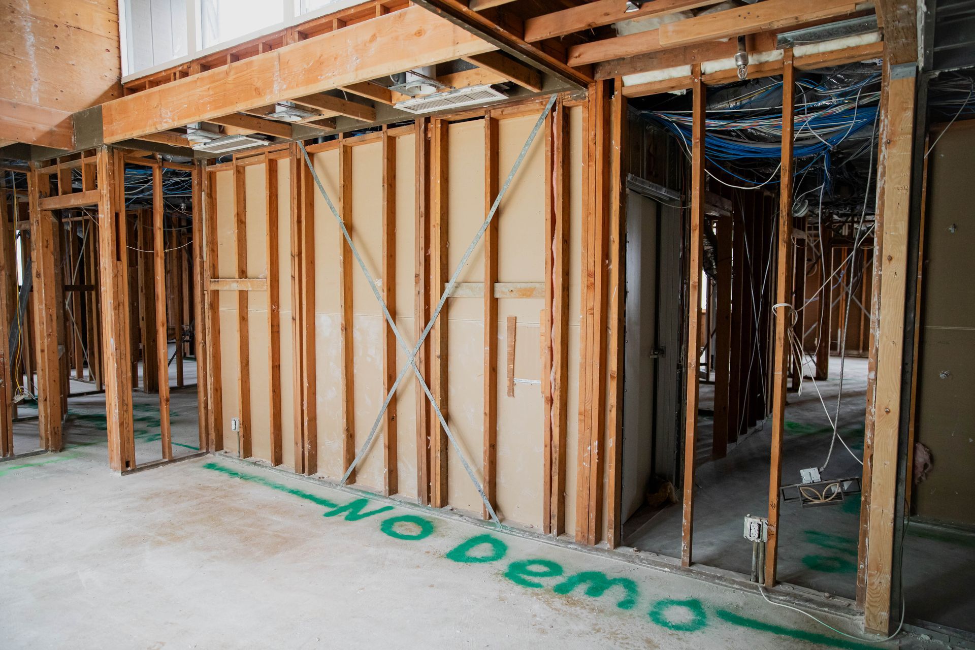 A building under construction with the words `` no demo '' written on the floor.