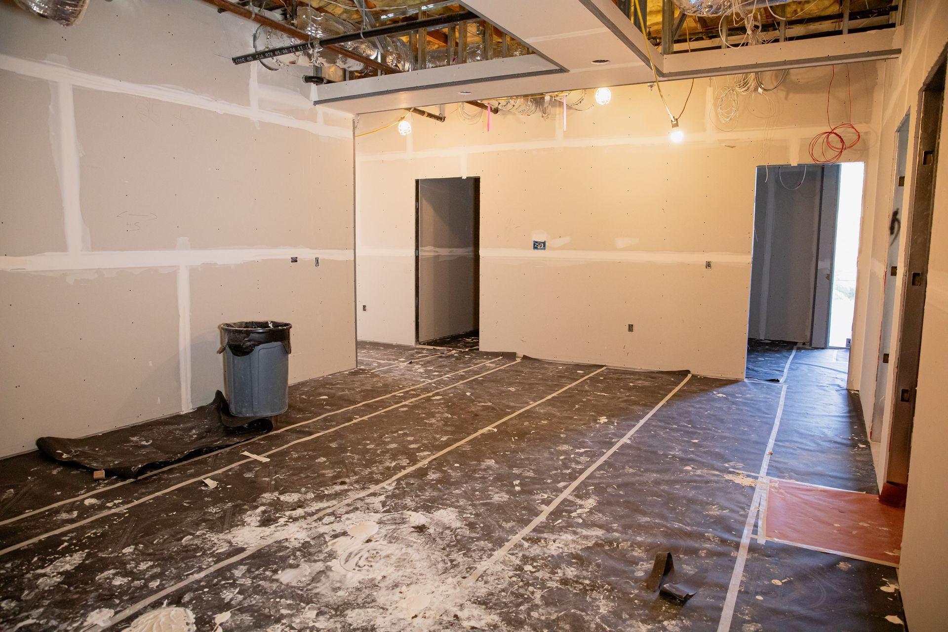 There is a trash can in the middle of the room.