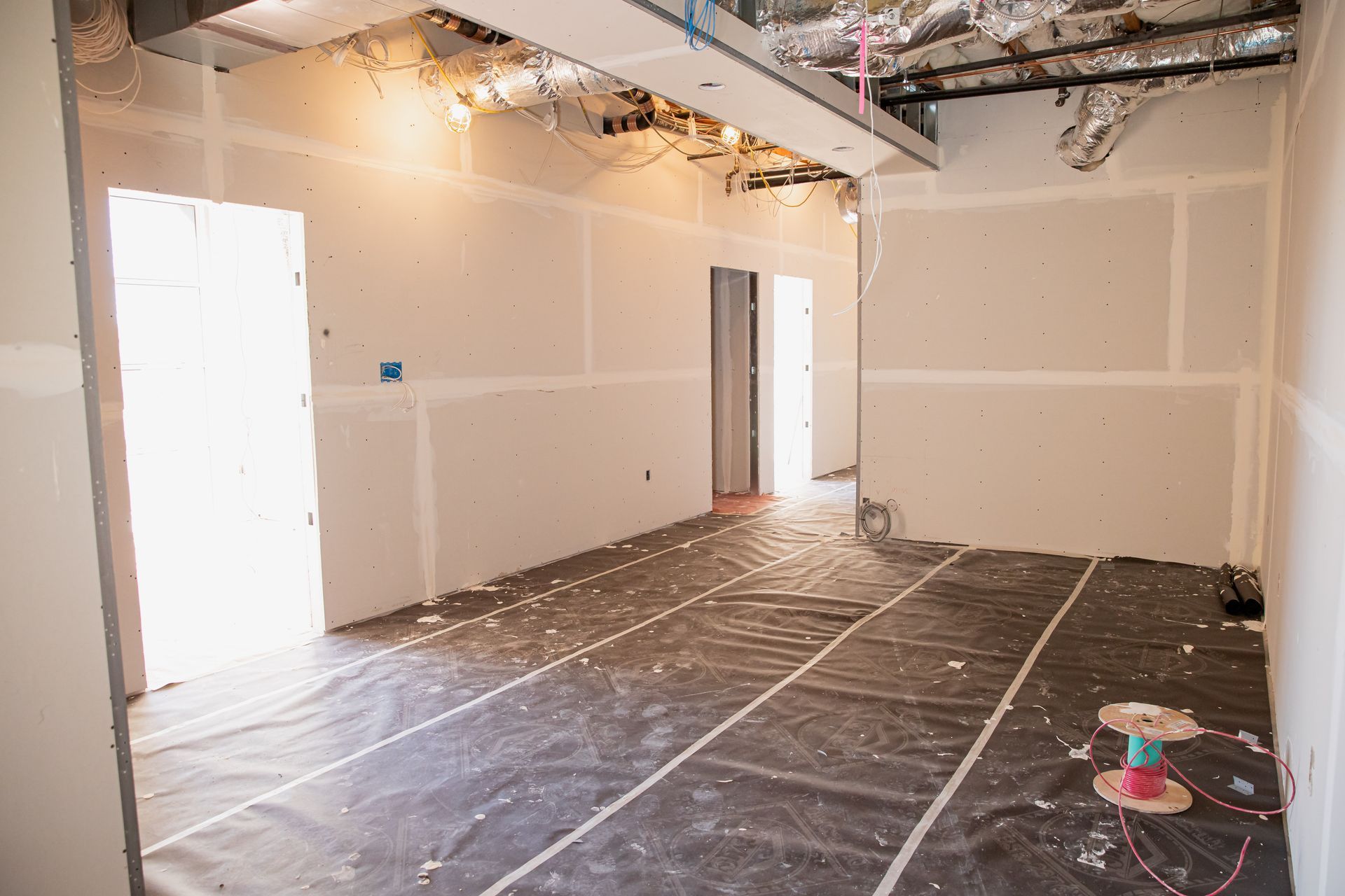 An empty room with a lot of tape on the floor.