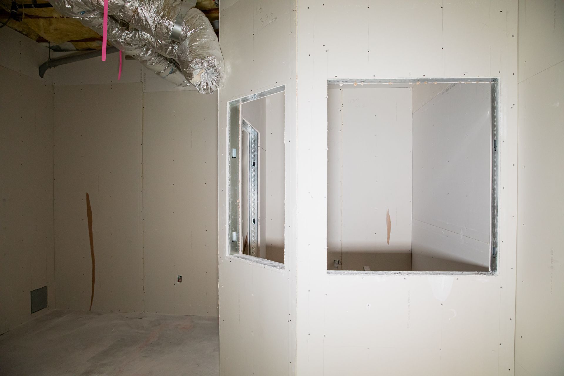 An empty room with a window in the wall.