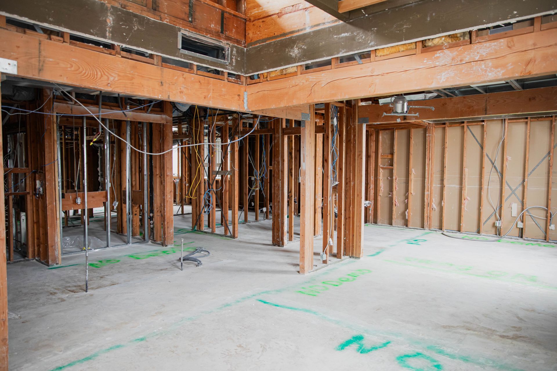The inside of a building under construction with wooden beams.