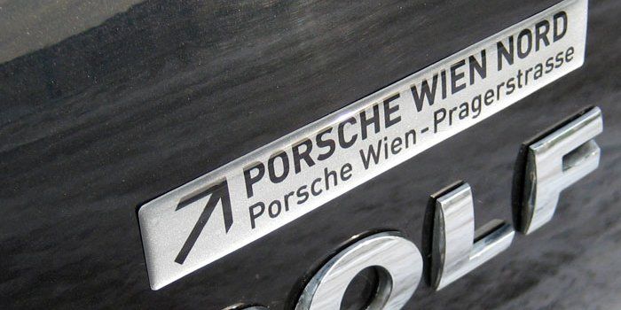 Eine Nahaufnahme eines Porsche Wien Nord Emblems auf einem Auto