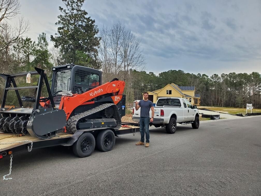 A man and a woman are sitting at a table looking at a cell phone.
