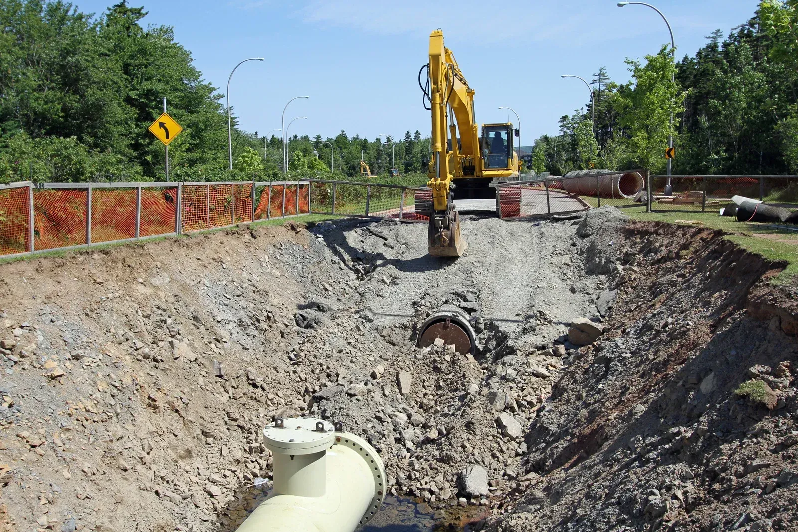 A man is standing on top of a building under construction.
