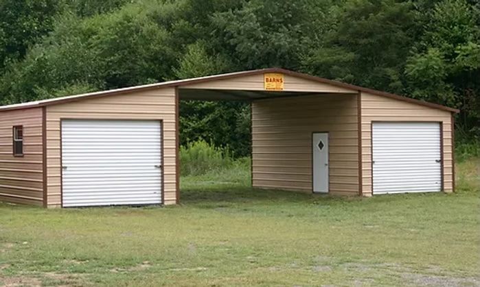 Tan metal garage with two doors and a covered walkway.