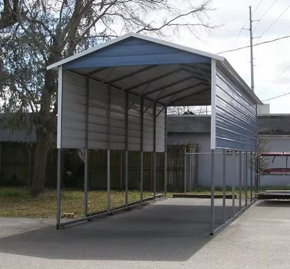 Blue and white metal carport on concrete, open-sided with a pitched roof, in an outdoor setting.