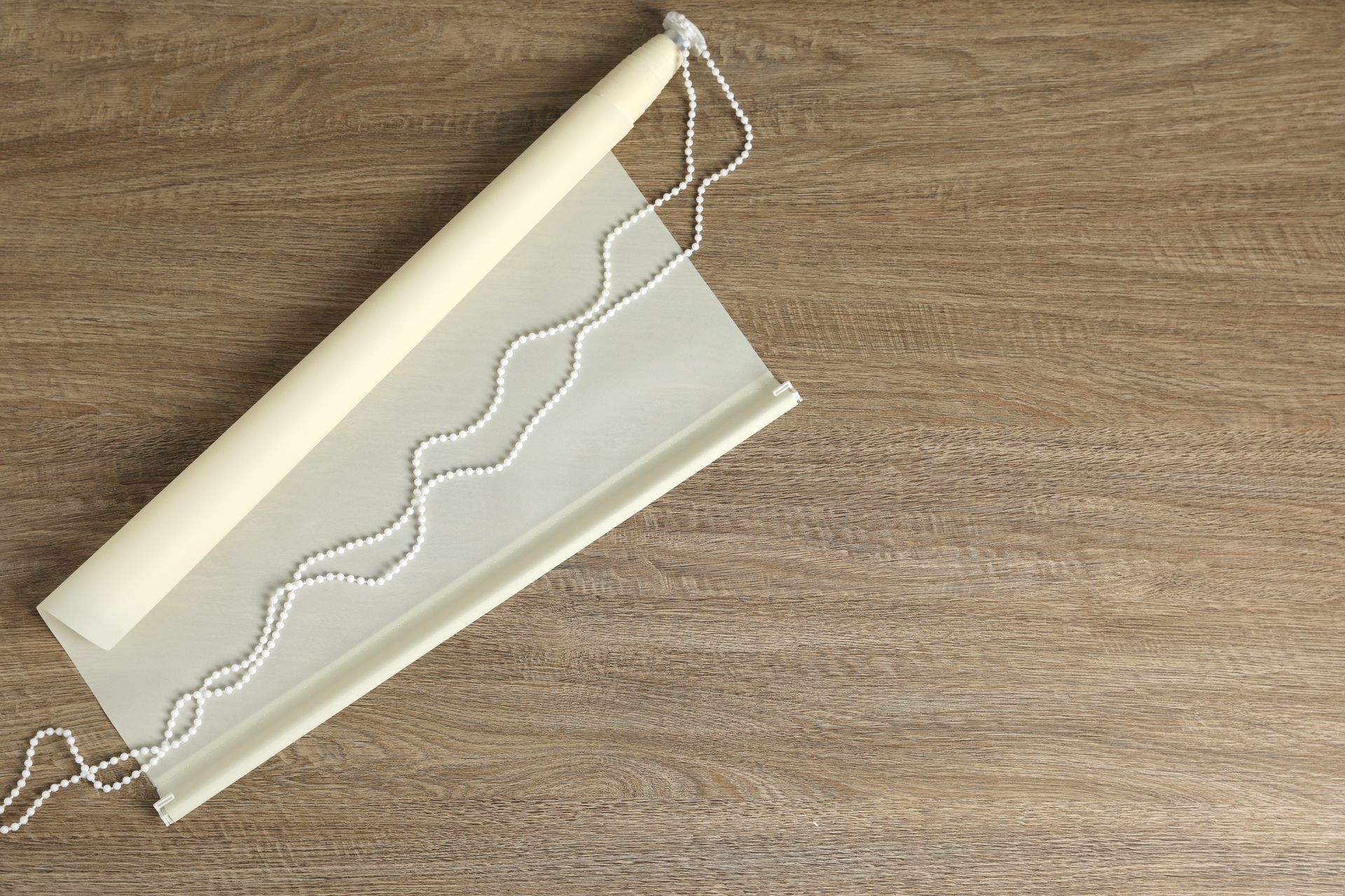 White roller shade draped on a floor near Marriottsville, MD.