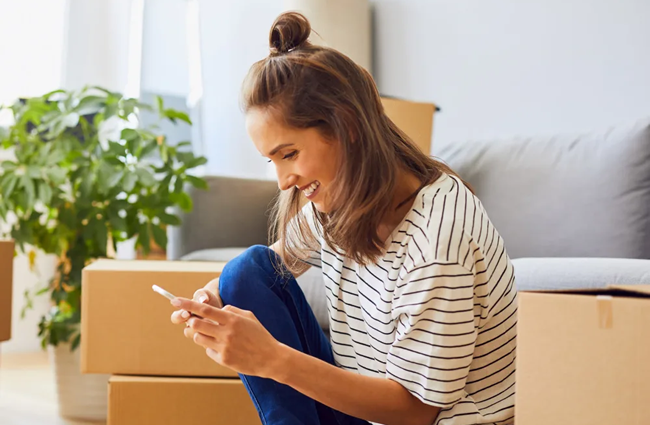 Image of a woman calling STOR-N-LOCK Self Storage on her mobile phone to talk about available job opportunities.